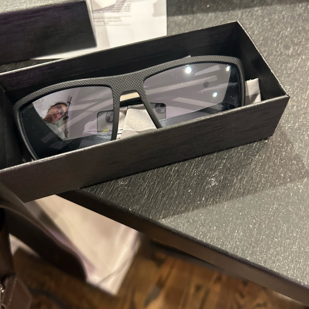 Black sunglasses with mirrored lenses.